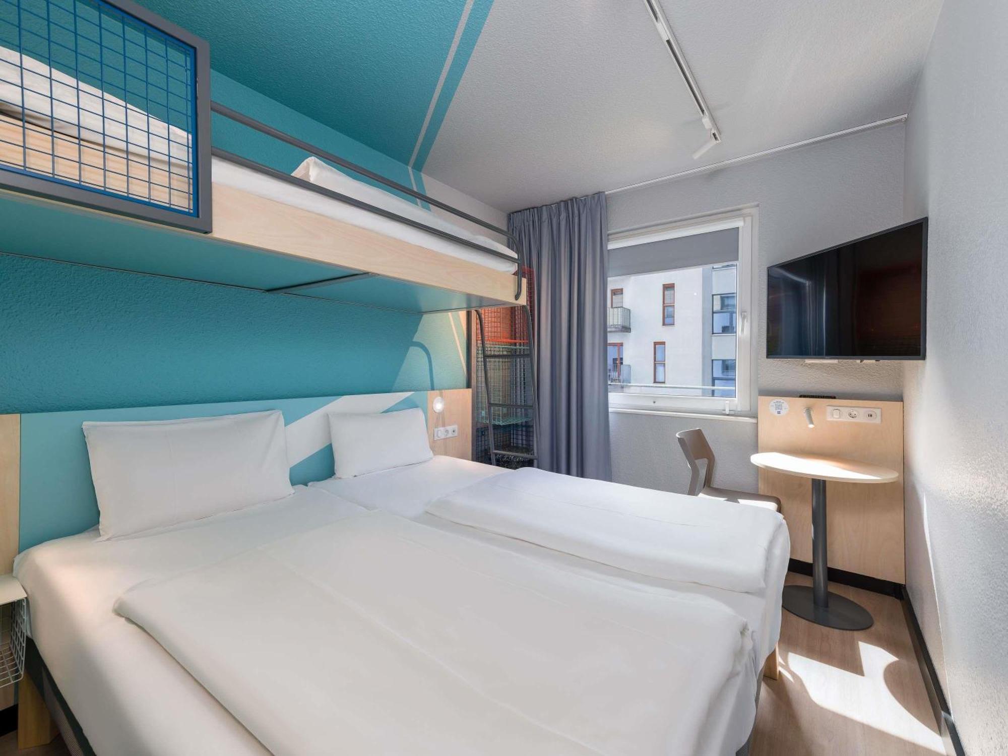 Small triple room with two single beds and a bunk bed